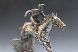 A HALLMARKED SILVER (FILLED) MODEL OF A RACEHORSE LANDING A JUMP AFTER DAVID GEENTY - SHEFFIELD