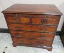 A 19TH CENTURY MAHOGANY BACHELORS CHEST OF DRAWERS OF SLIM PROPORTIONS, having brushing slide, two