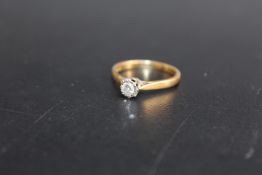 A HALLMARKED 18 CARAT GOLD DIAMOND SOLITAIRE RING, the illusion set diamond being of an estimated 10