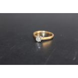 A HALLMARKED 18 CARAT GOLD DIAMOND SOLITAIRE RING, the illusion set diamond being of an estimated 10