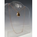 AN 18CT GOLD LOCKET STAMPED 750, suspended on an 18ct rose gold chain, combined weight approx. 16.