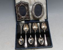 A CASED SET OF HALLMARKED SILVER TEASPOONS - SHEFFIELD 1931, together with two small modern photo