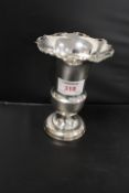 A HALLMARKED SILVER TRUMPET VASE, having filled base and frilled rim, H 14 cm