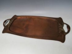 AN ARTS AND CRAFTS HAMMERED COPPER TRAY BY J.S. & S, of oblong form, with stylised Art Nouveau