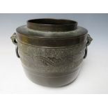 AN EARLY ORIENTAL DECORATIVE TWIN HANDLED BRONZE POT, H 20 cm, Dia. to rim 15 cm, Dia. to base 16.