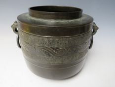 AN EARLY ORIENTAL DECORATIVE TWIN HANDLED BRONZE POT, H 20 cm, Dia. to rim 15 cm, Dia. to base 16.