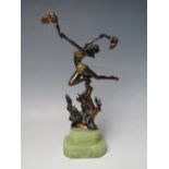 AN ART DECO STYLE BRONZED METAL FIGURE OF A FIRE DANCER, with gilt and copper painted accents to the
