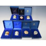 A COLLECTION OF SEVEN HALCYON DAYS ENAMEL PILL BOXES, comprising 'Princess Royal' steam train for