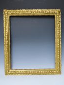 A LATE 19TH / EARLY 20TH CENTURY DECORATIVE GOLD FRAME, with bead design to inner edge and plant