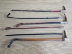 A COLLECTION OF SIX EQUESTRIAN THEMED RIDING CROPS TO INCLUDE A SILVER COLLARED EXAMPLE