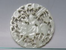 AN ORIENTAL RETICULATED CIRCULAR JADE PANEL, depicting a figure on horseback, Dia. 5.5 cm