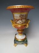 A LARGE PORTUGESE TWIN HANDLED CAMPANA SHAPED URN, raised on a squared base with four gilt feet,