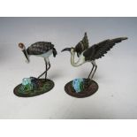 TWO ORIENTAL SILVER AND ENAMEL FIGURES OF CRANES, both marked 'SILVER' to the underside, tallest H