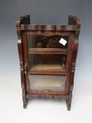 A LATE 19TH CENTURY MAHOGANY GLAZED TABLE TOP CABINET, with single door, three interior pull-out