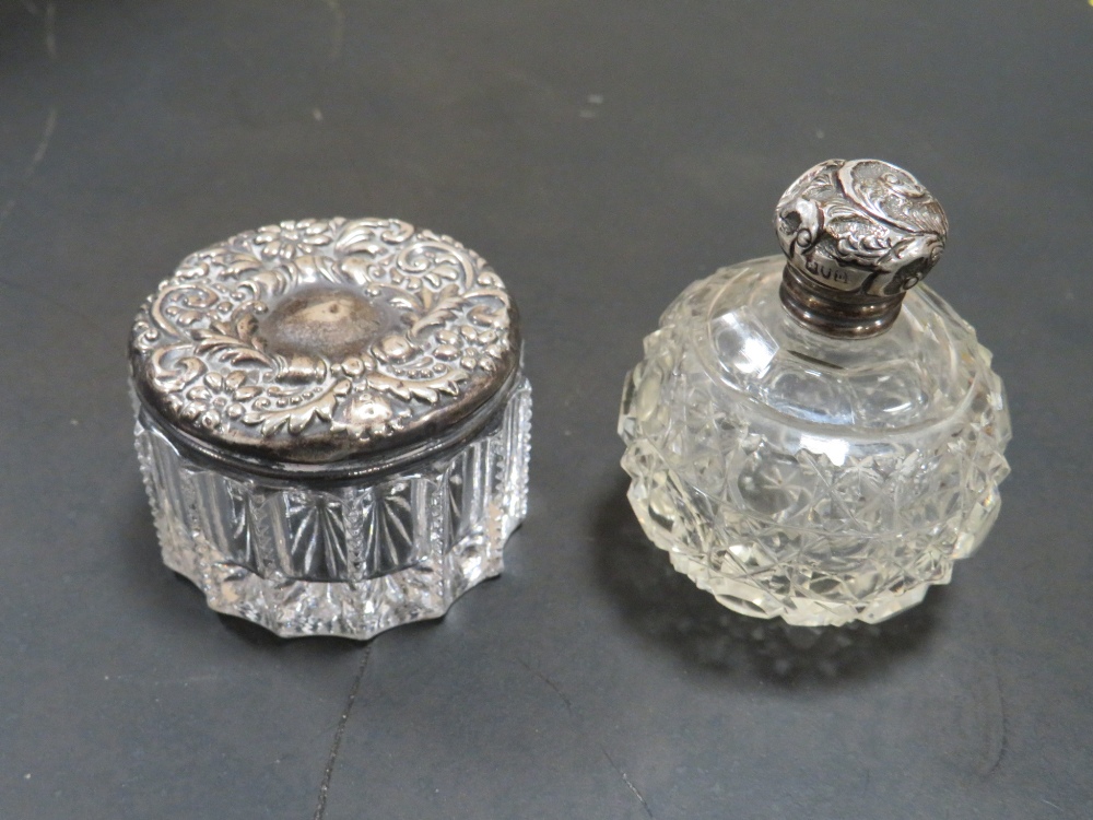 TWO SILVER TOPPED VANITY JARS