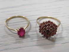 A LADIES 10K GEMSET RING TOGETHER WITH A YELLOW METAL GARNET CLUSTER RING (2)