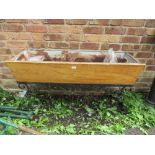 A VINTAGE WOODEN TROUGH ON WROUGHT IRON BASE