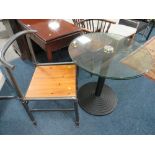 A MODERN GLASS TOP TABLE WITH AN INDUSTRIAL STYLE CHAIR
