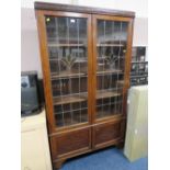 A VINTAGE OAK GLAZED TWO DOOR LEADED BOOKCASE H-183 W-102 CM