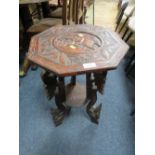 AN EASTERN CARVED TWO TIER OCCASIONAL TABLE