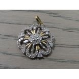 A LADIES 10CT DIAMOND SET FLORAL PENDANT