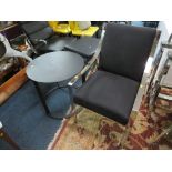 A MODERN BLACK AND CHROMED ARMCHAIR WITH BLACK METAL TABLE (2)
