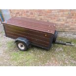 A SMALL OLD TWO WHEEL CAR TRAILER WITH TAILBOARD