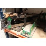 A CAST IRON MITRE GUILLOTINE WITH MITRE SAW AND VARIOUS WOOD SAWS