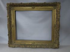 A 19TH CENTURY DECORATIVE GOLD FRAME WITH GOLD SLIP, frame W 12 cm, slip rebate 77 x 64 cm, frame