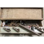 A GREY PAINTED WOODEN CARPENTERS TOOLBOX CONTAINING VARIOUS TOOLS AND PLANERS