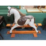 AN EARLY 20TH CENTURY 'NORMAN WOOD' ROCKING HORSE ON PINE TRESTLE BASE, bearing label to neck,