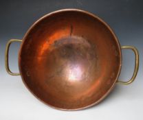 A LARGE BRASS AND COPPER TWIN HANDLED DOMED BOWL, H 24 cm, Dia. 70 cm