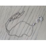 A LADIES 10K DIAMOND SET WHITE GOLD PENDANT ON A 9CT WHITE GOLD CHAIN