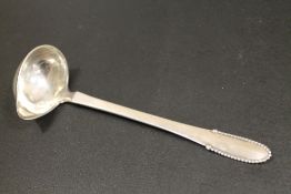 A VINTAGE GEORGE JENSEN STERLING SILVER LADLE