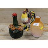 A NOVELTY MUSICAL BOTTLE TOGETHER WITH A SATIN GLASS VASE AND A FIGURE OF A COCKEREL (3)