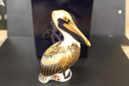 A ROYAL CROWN DERBY PAPERWEIGHT IN THE FORM OF A BROWN PELICAN - WITH BOX
