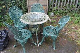 A GREEN PAINTED PATIO TABLE AND FOUR CHAIRS