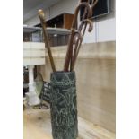 A SMALL COLLECTION OF WALKING STICKS IN A CERAMIC STAND