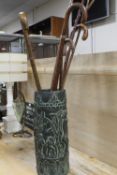 A SMALL COLLECTION OF WALKING STICKS IN A CERAMIC STAND