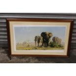 A LARGE FRAMED AN GLAZED DAVID SHEPHERD PRINT OF ELEPHANTS ENTITLED 'THE IVORY IS THEIRS' - NB NEEDS