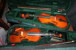 TWO CASED TINY VIOLINS;
