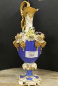 AN ORNATE ANTIQUE GILT EWER DECORATED WITH FLOWERS AND BUNCHES OF GRAPES - A/F BADLY DAMAGED AND