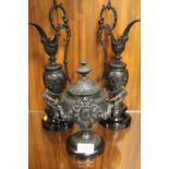 A CAST METAL TWIN HANDLED LIDDED POT AND COVER TOGETHER WITH A PAIR OF SIMILAR STYLE EWERS (3)