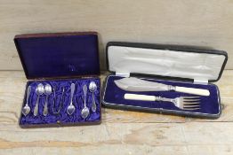 A CASED SET OF WMF TEASPOONS AND SUGAR TONGS