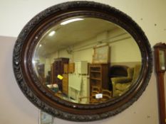 A VINTAGE OVAL WALL MIRROR