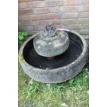 A CIRCULAR STONE / CONCRETE WATER FEATURE