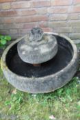 A CIRCULAR STONE / CONCRETE WATER FEATURE