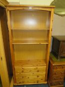 A MODERN HONEY PINE OPEN FLOOR STANDING BOOKCASE WITH THREE DRAWERS BELOW W 87 CM