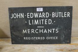 A VINTAGE METAL SIGN 'JOHN EDWARD BUTLER MERCHANTS'