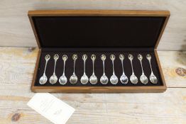A SET OF 12 SOLID SILVER R.S.P.B. SPOONS IN PRESENTATION CASE